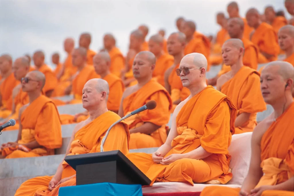 Mass meditation event with monks seated in rows at Wat Phra Dhammakaya
